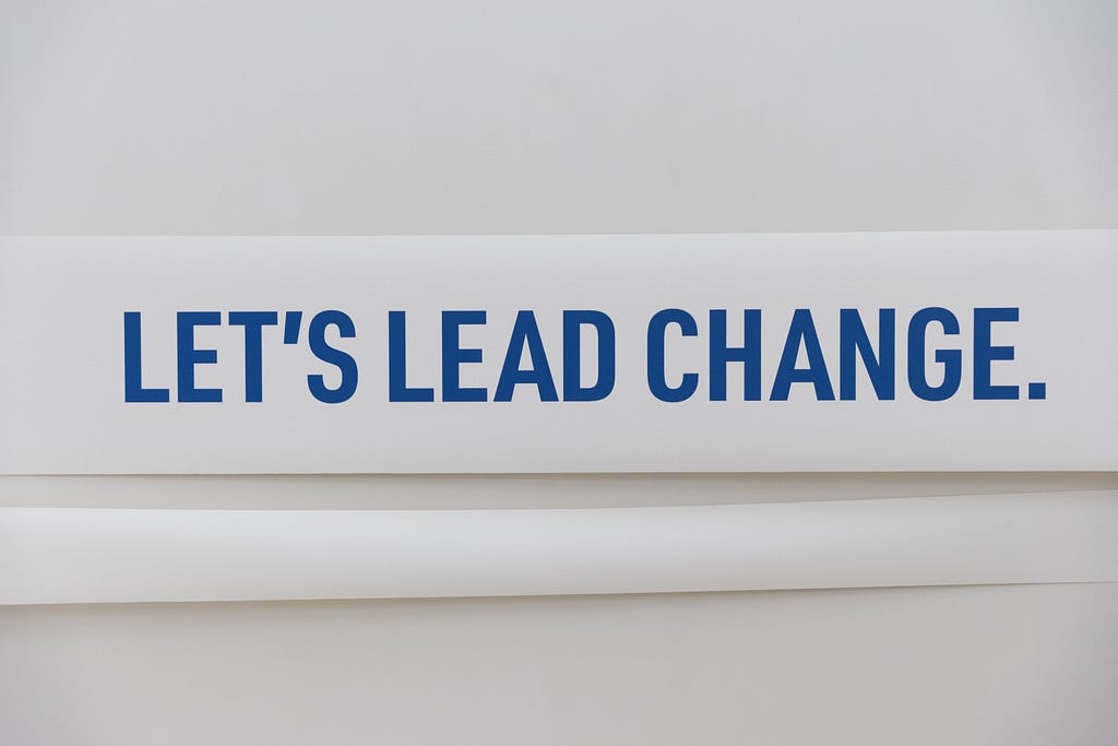 Banner reading: “let’s lead change”.