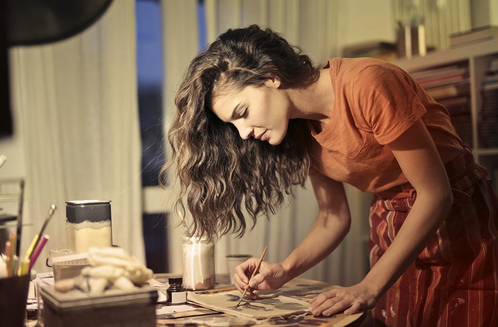 a girl painting in her studio