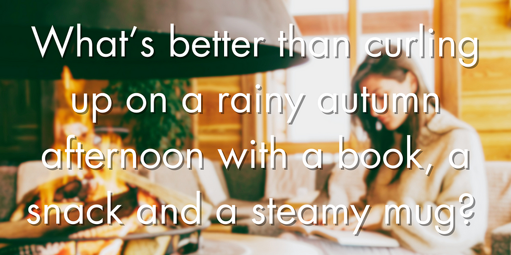 A blurry fall cabin background with a young white woman in a sweater reading beside a fireplace with text overlaid asking, “What’s better than curling up on a rainy autumn afternoon with a book, snack, and a steamy mug?”