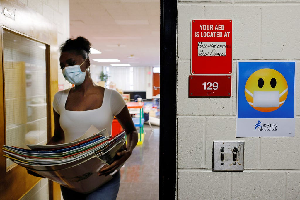 A Kindergarten teacher cleans and prepares her classroom, where she will begin the new school year teaching virtually because of the COVID-19 pandemic, in Boston, Massachusetts, September 18, 2020. Photo by Brian Snyder/Reuters