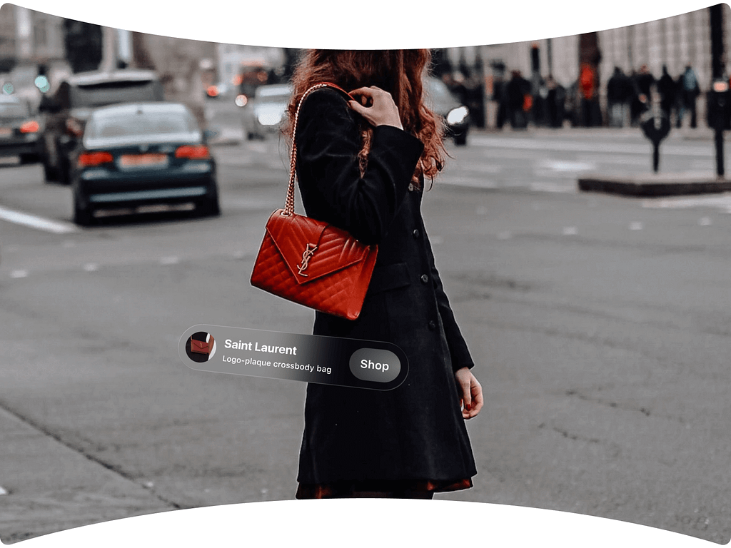 An AR headset user views a real person on the street holding a red quilted bag. An augmented pop-up identifies the bag as a luxury brand with a clickable option to shop.