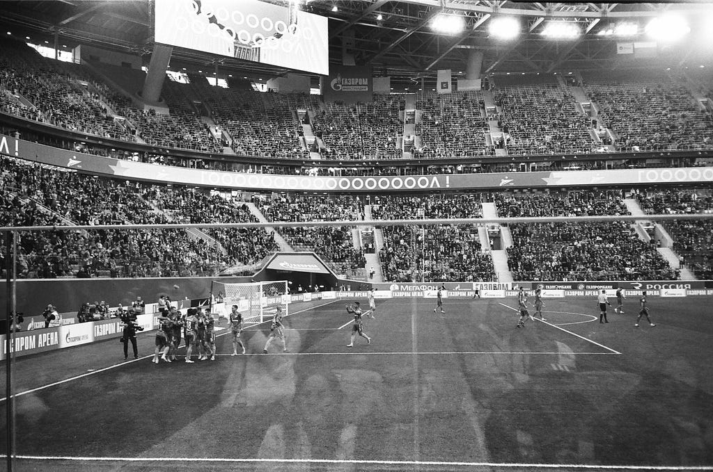 Football players celebrating goal at a football stadium