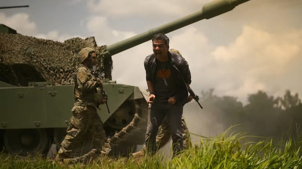 A screencap from the film showing Wagner Moura as Joel screaming while soldiers and a tank move behind him.