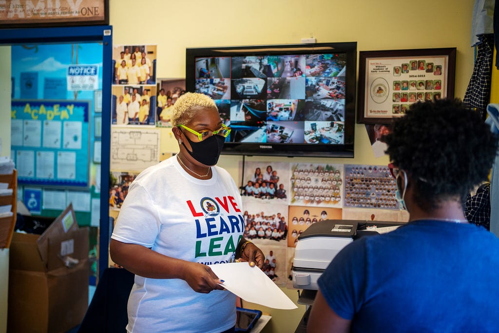 Wilcox Academy owner Rochelle Wilcox (L) speaks with teacher Briceshanay Gresham as childcare centers struggle to hire staff in New Orleans, Louisiana, August 24, 2021. Photo by Kathleen Flynn/Reuters