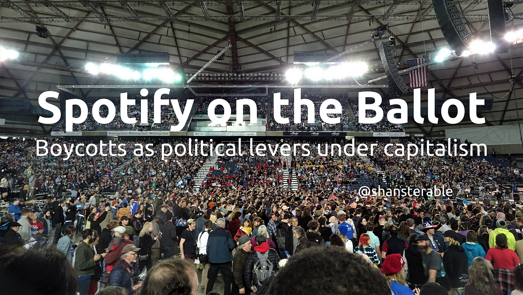 Spotify on the Ballot: Boycotts as political levers under capitalism. Image of a crowd at a political rally at the Tacoma Dome.