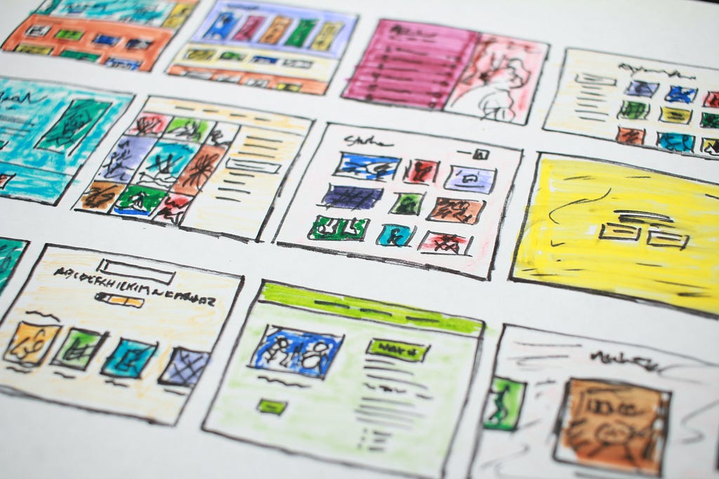 Multiple website layouts, hand-drawn and colored, can be seen. These illustration drafts are used for planning and layouting before the final product.