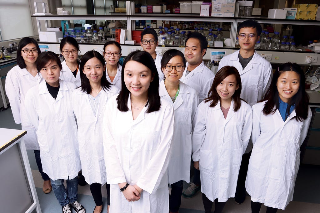 Dr. Carmen Wong in the centre of her team at the HKUMed research lab