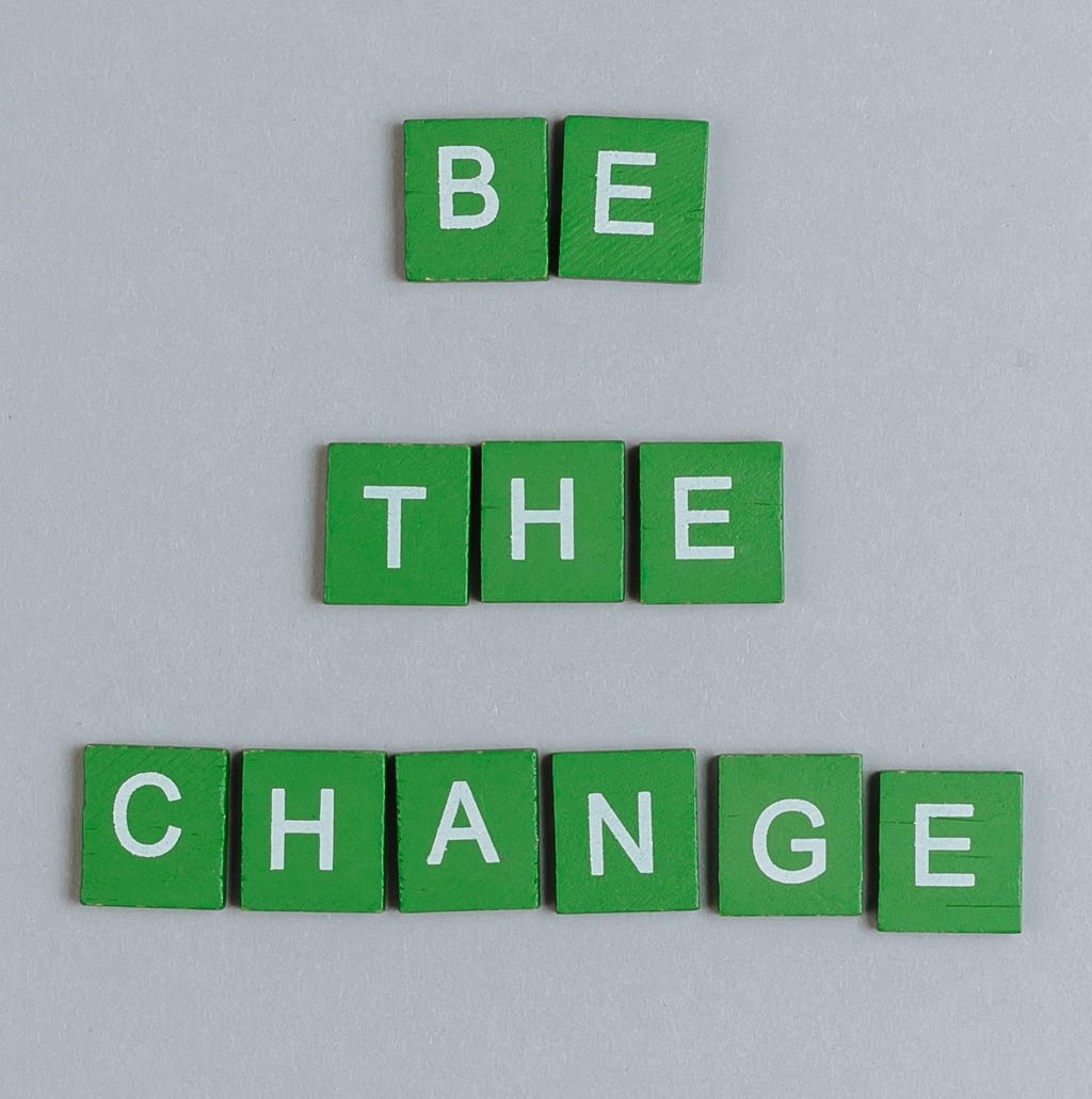 “Be the change” on a solid color background
