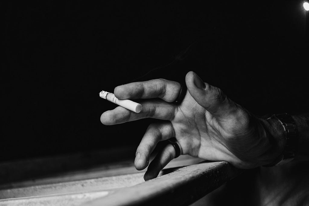 a hand with a cigarette