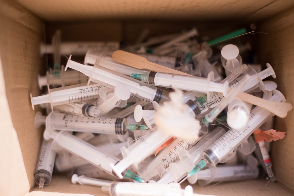 A look inside a box of used syringes.