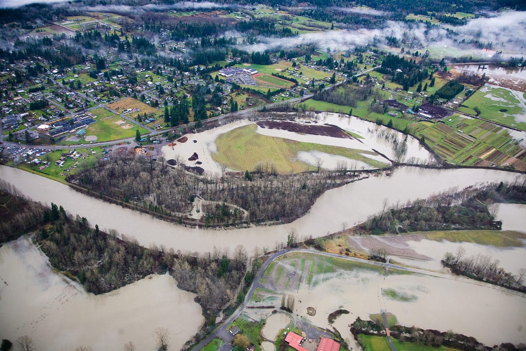 Aerial photo of the Fall City Floodplain Restoration Project, showing the Snoqualmie River and farmland. Photo credit: King County Water and Land Use Division.
