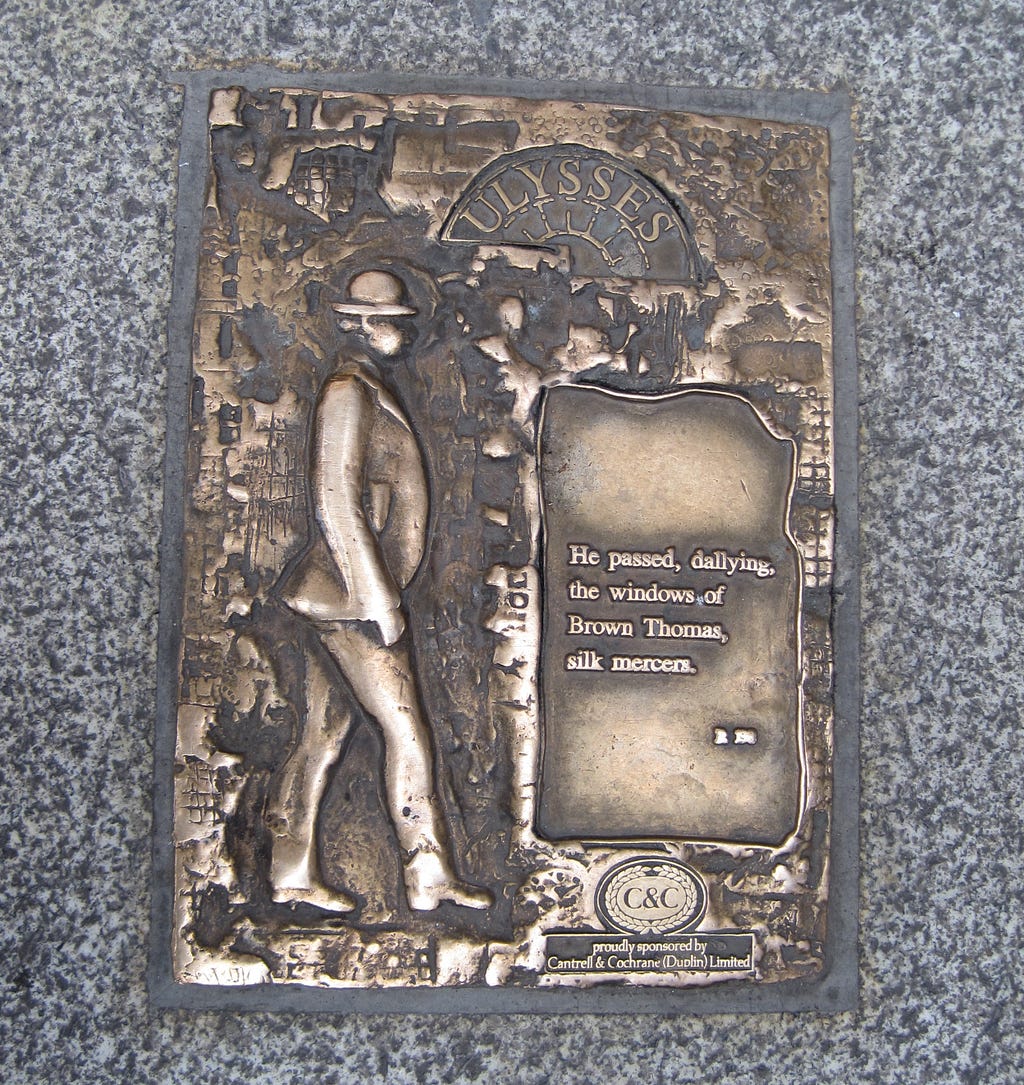 Dublin plaque of Ulysses character Leopold Bloom. “He passed, dallying, the windows of Brown Thomas, silk mercers.”