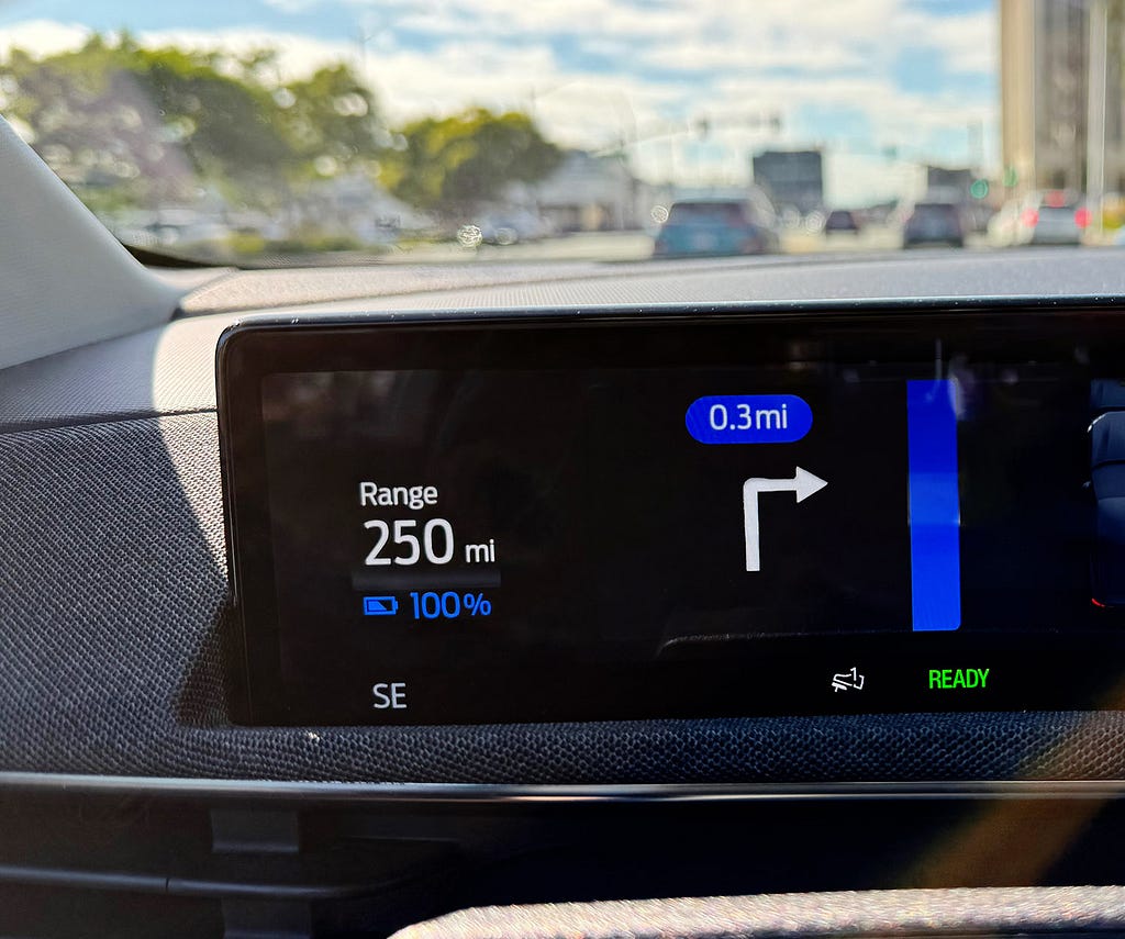 View of the dashboard showing 250 miles range at 100% battery