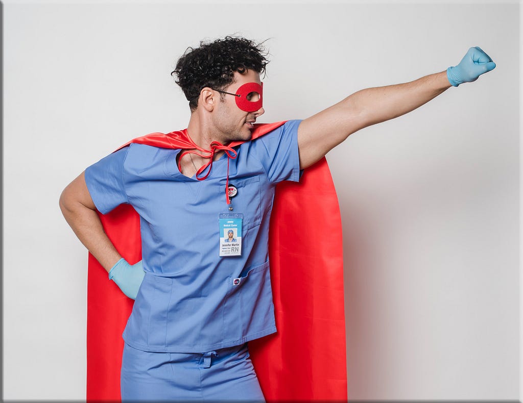 Male nurse dressed in superhero cape and mask
