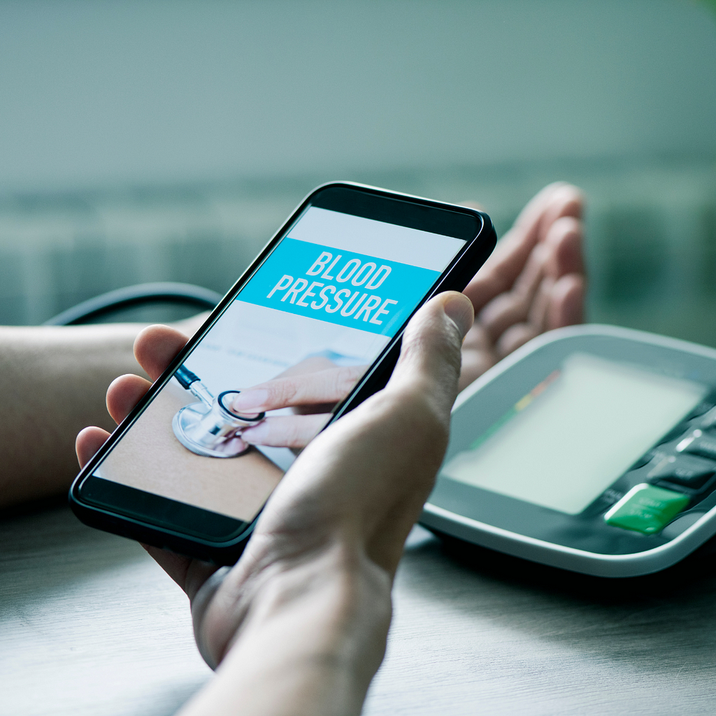 A smartphone depicting a blood pressure reading.