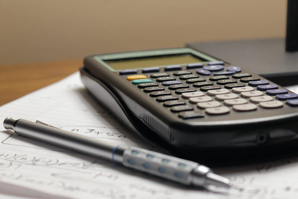 Calculator Sitting on Notepad