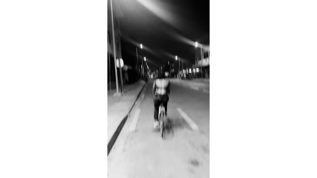 A blurry image of me riding a bike