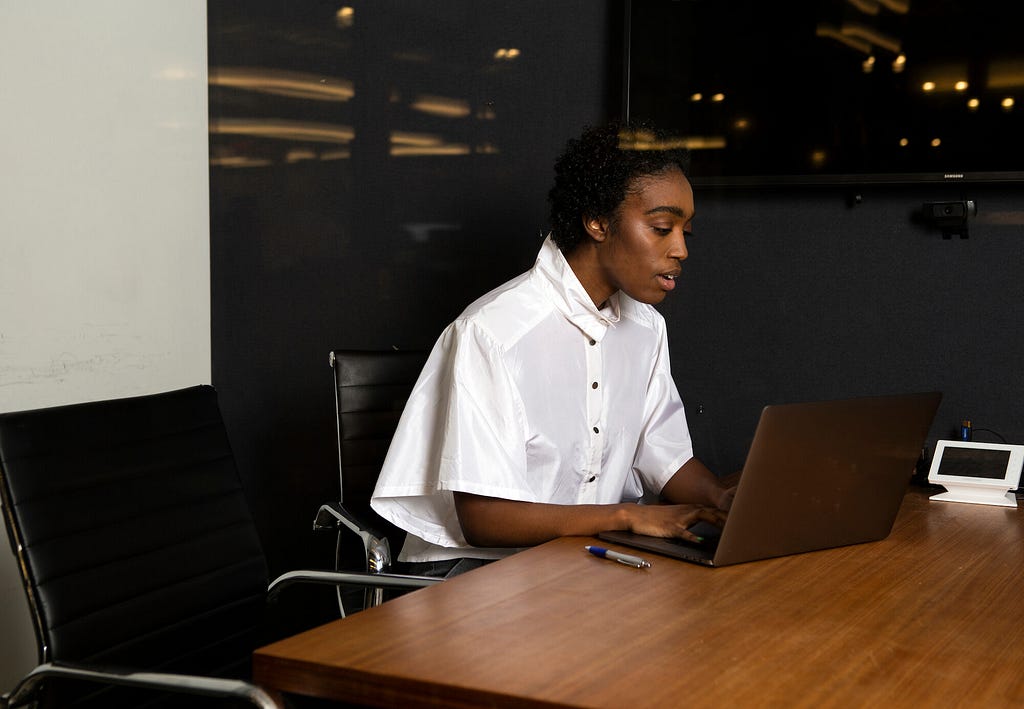 A non-binary person using a laptop at work. Photo credit: The Gender Spectrum Collection