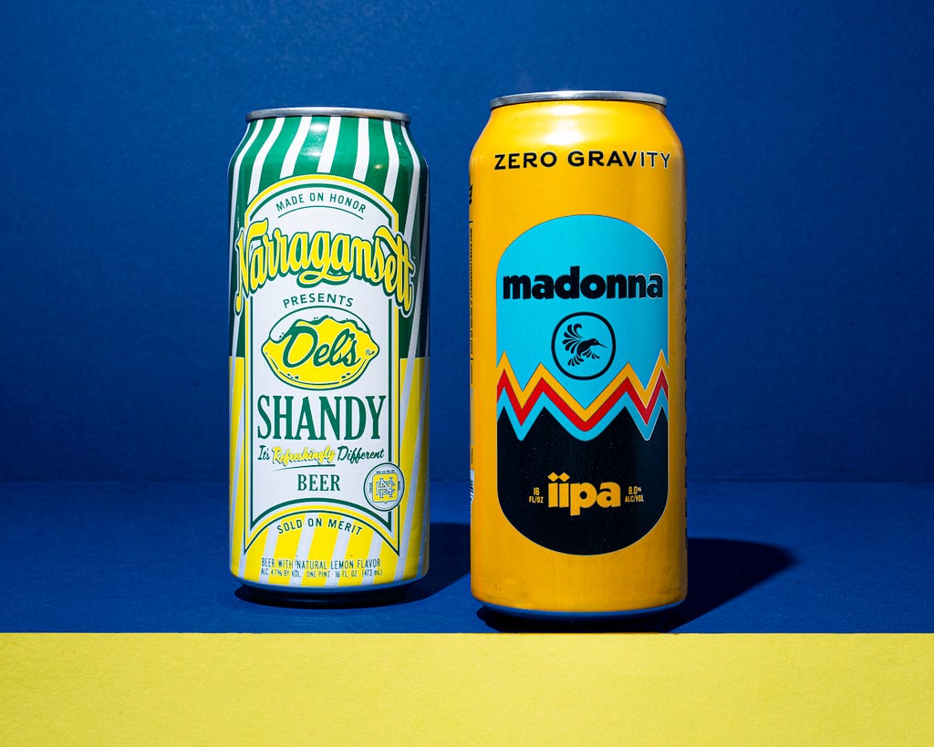 Narragansett Brewing’s De;’s Shandy beer can next to Zero Gravity Brewery’s can design of Madonna Double IPA. Both use vintage graphics to convey a convey a sense of heritage and nostalgic feelings.