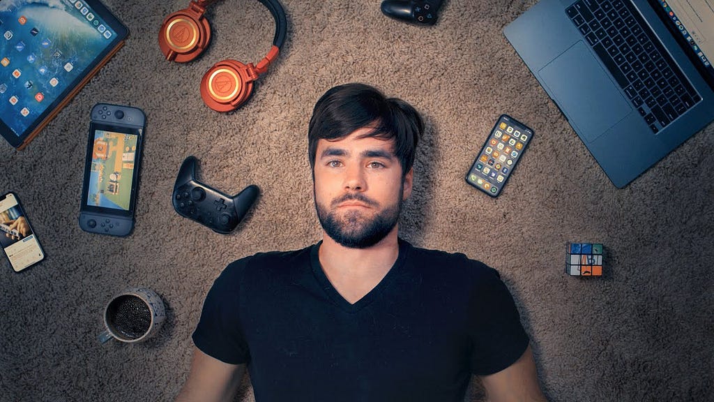 Thomas J Frank YouTuber lying on the floor with multiple devices showing Notion Templates.