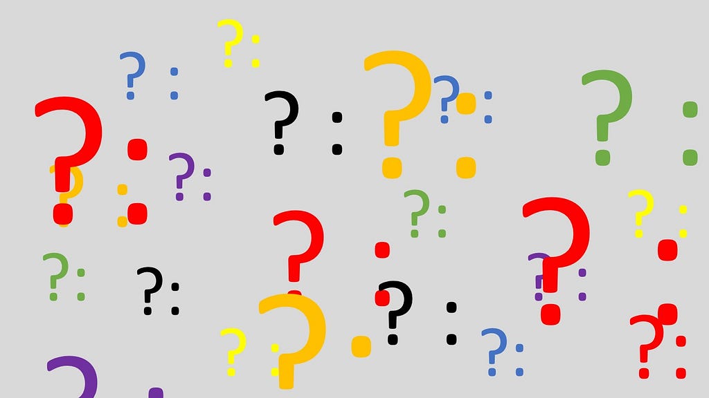 Question marks and colons in different colors and sizes