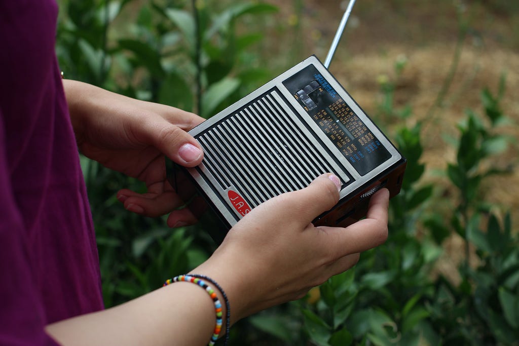 Man holding a shortwave radio receiver in his hands