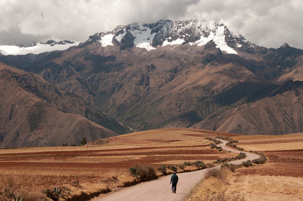 A farmer walks along a road in the Andes of Peru. (© April Orcutt — all rights reserved)
