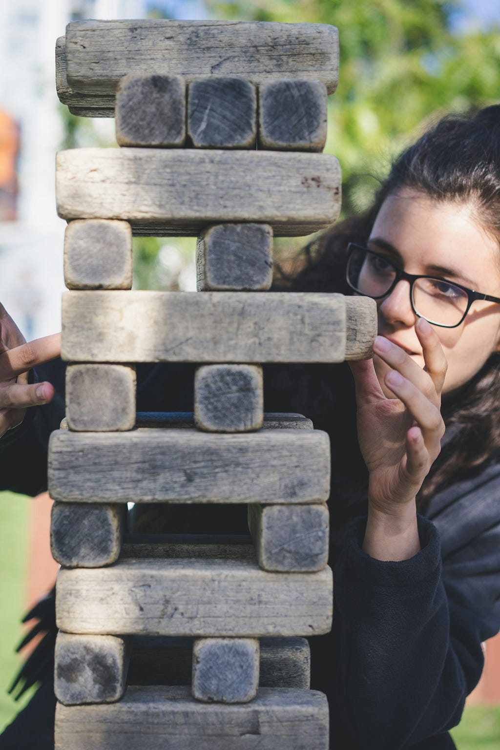 A woman playing a Jenga type game.