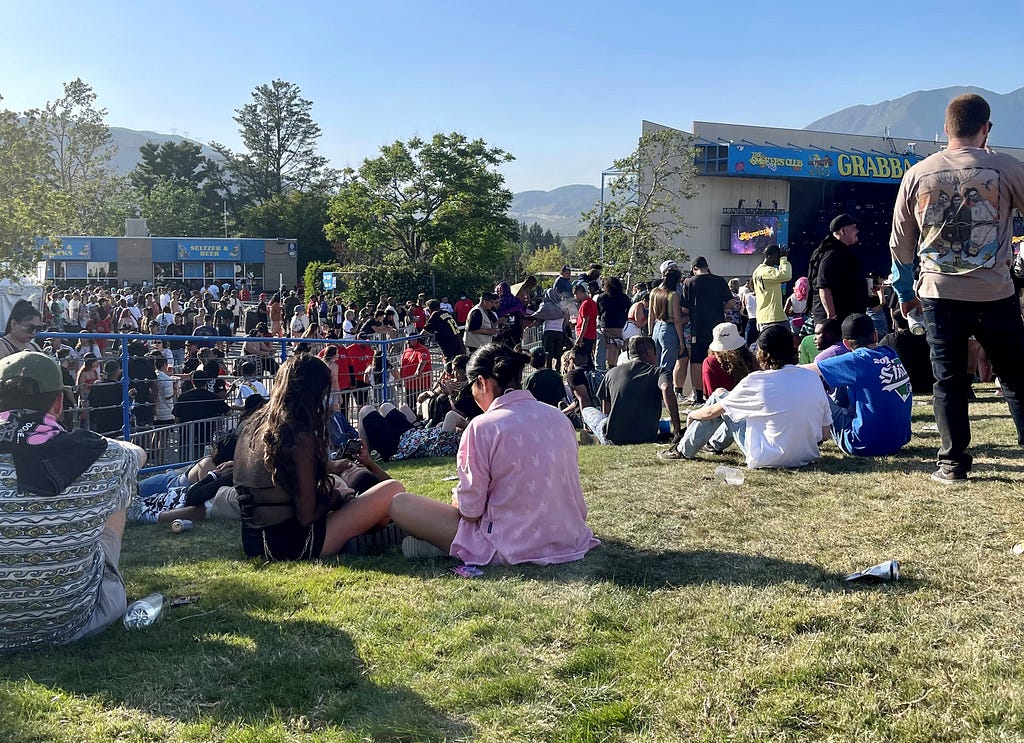 a view from the grassy field of a music festival in progress