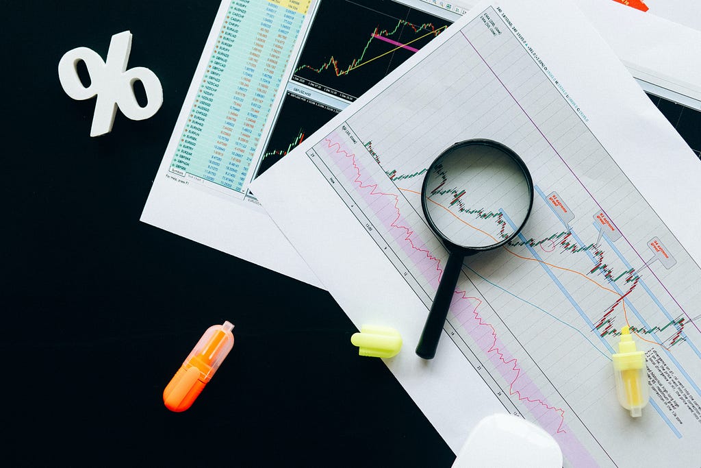An image of a magnifying glass analyzing stock market charts and data, symbolizing the importance of research and analysis in understanding share prices and making informed investment decisions