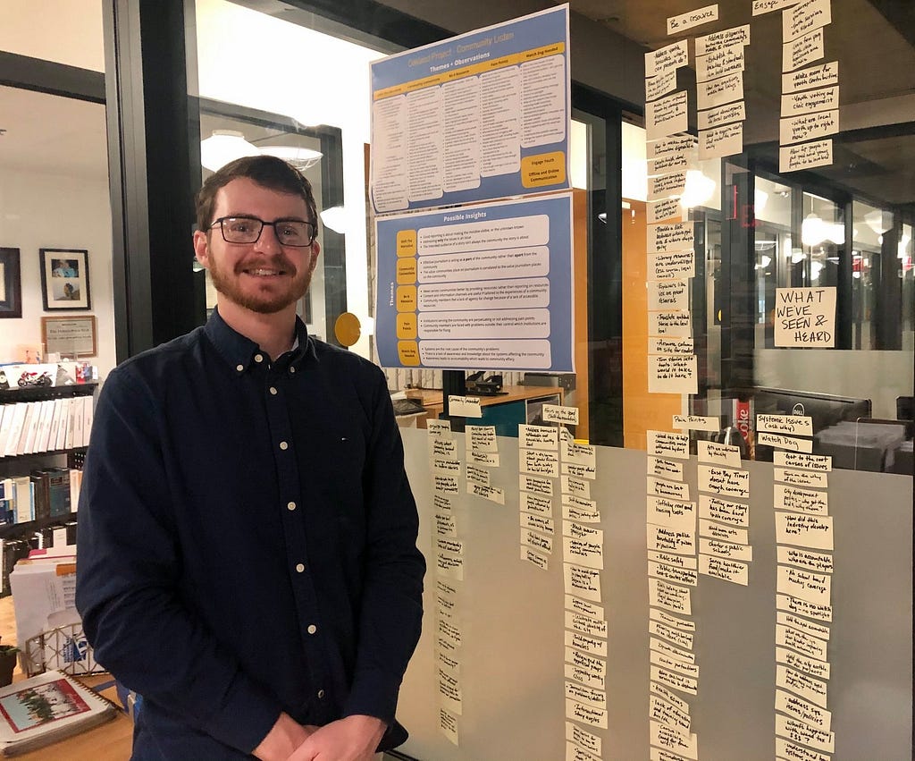 Andrew Weiler posing next to his human centered design research data at Berkeleyside last Fall