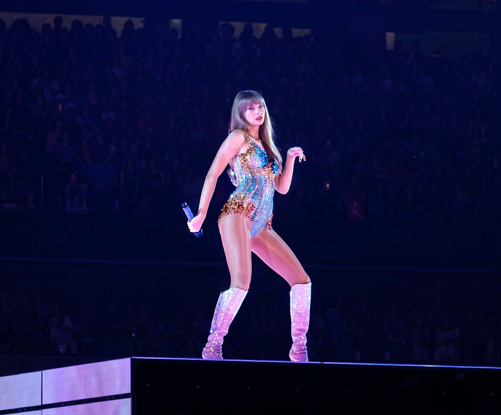 Taylor Swift on stage wearing a daimond encrested leatard.