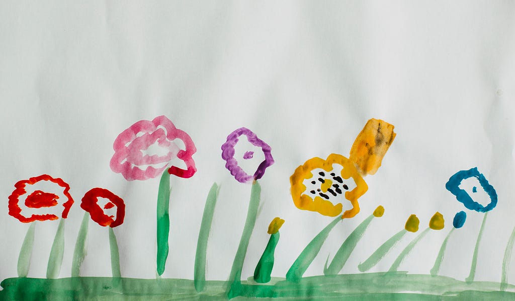 A child’s painting of flowers in various colours
