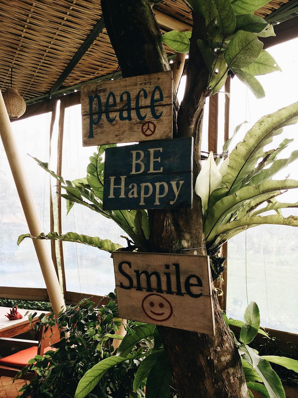 Wood slabs with inscriptions: Peace, Be Happy, Smile.