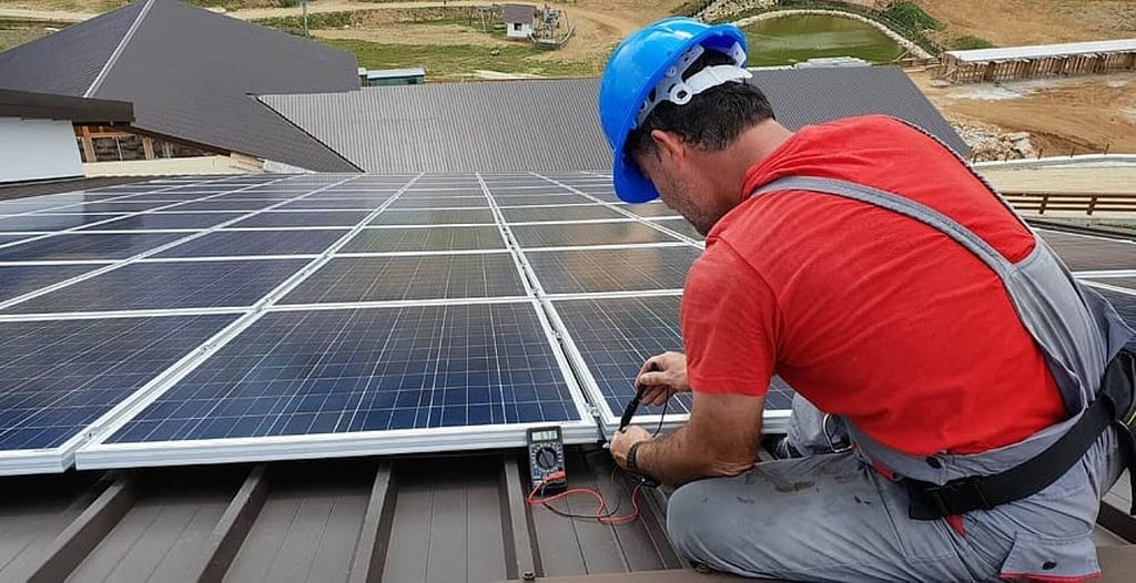 Solar panel installation in Orem by Ask Solar Mike, with a technician on a rooftop.