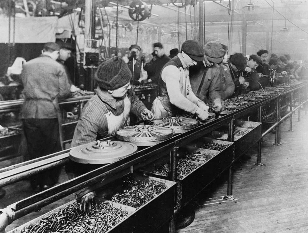 Black and white photograph of an assembly line from 1913
