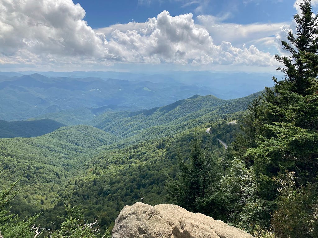 View from Waterrock Knob, rolling hills into the distance, clouds in a blue sky