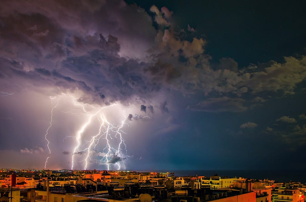 The call home: thunder and lightning in the sky, striking a city.