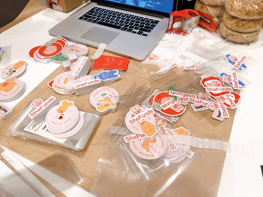 Picture of stickers laid out on a table ready to be packaged and shipped