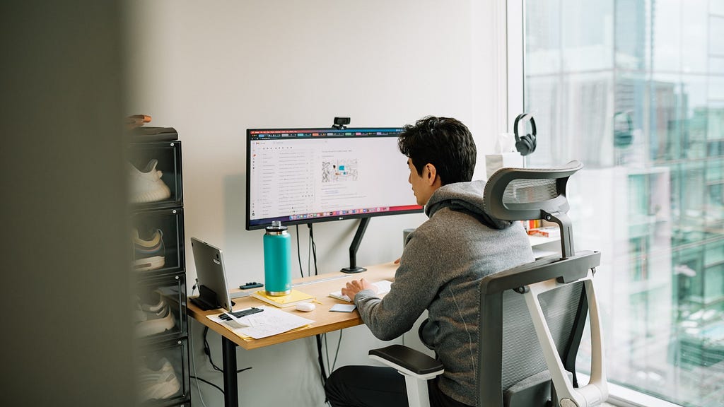 Dropbox employee working from desk at home.