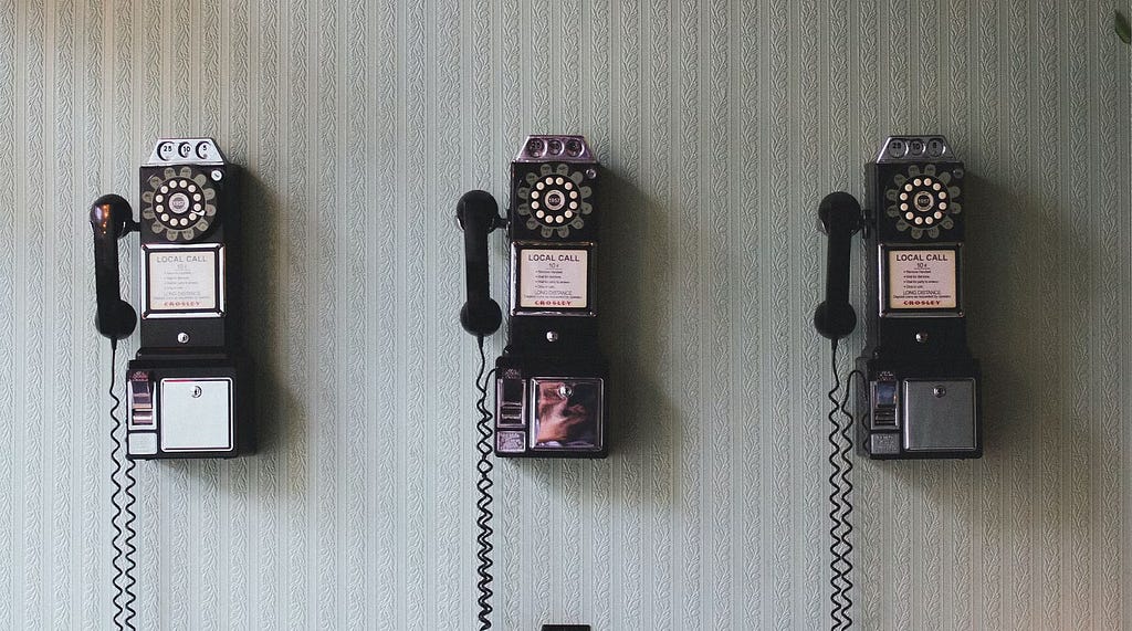 three landline telephones from the early twentieth century