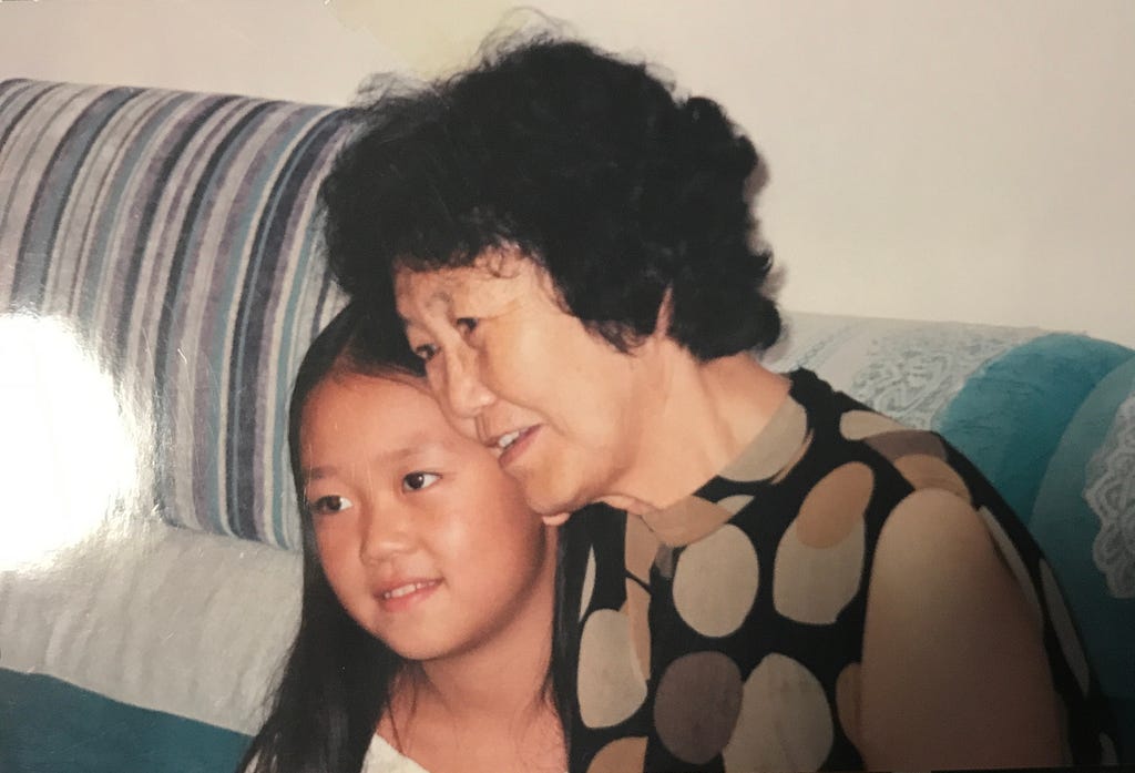 Young photo of author with grandmother