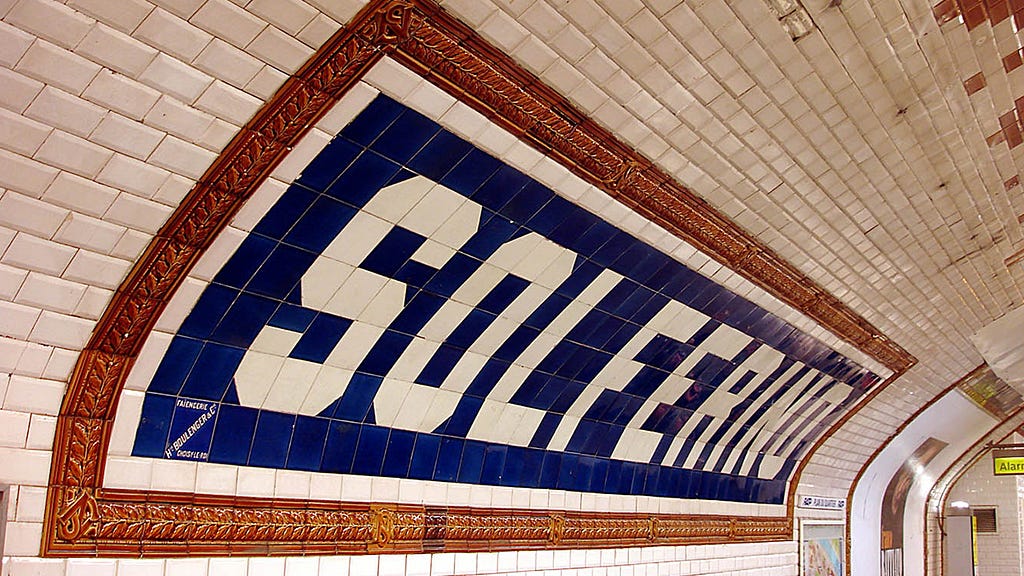 A big sign on a metro platform