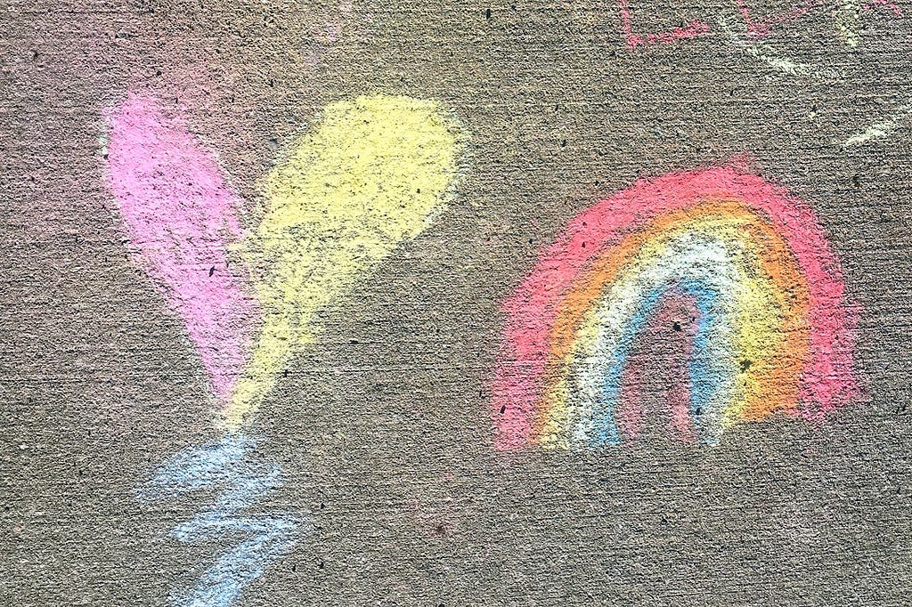 kid’s sidewalk chalk drawing of heart and rainbow