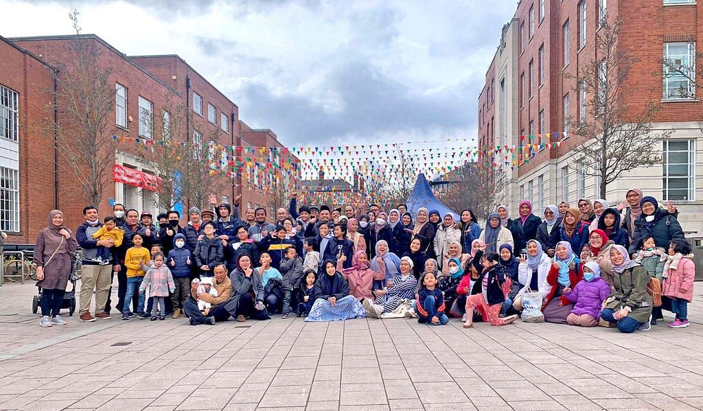 A group shot of people of many ages on the University of Leeds campus.