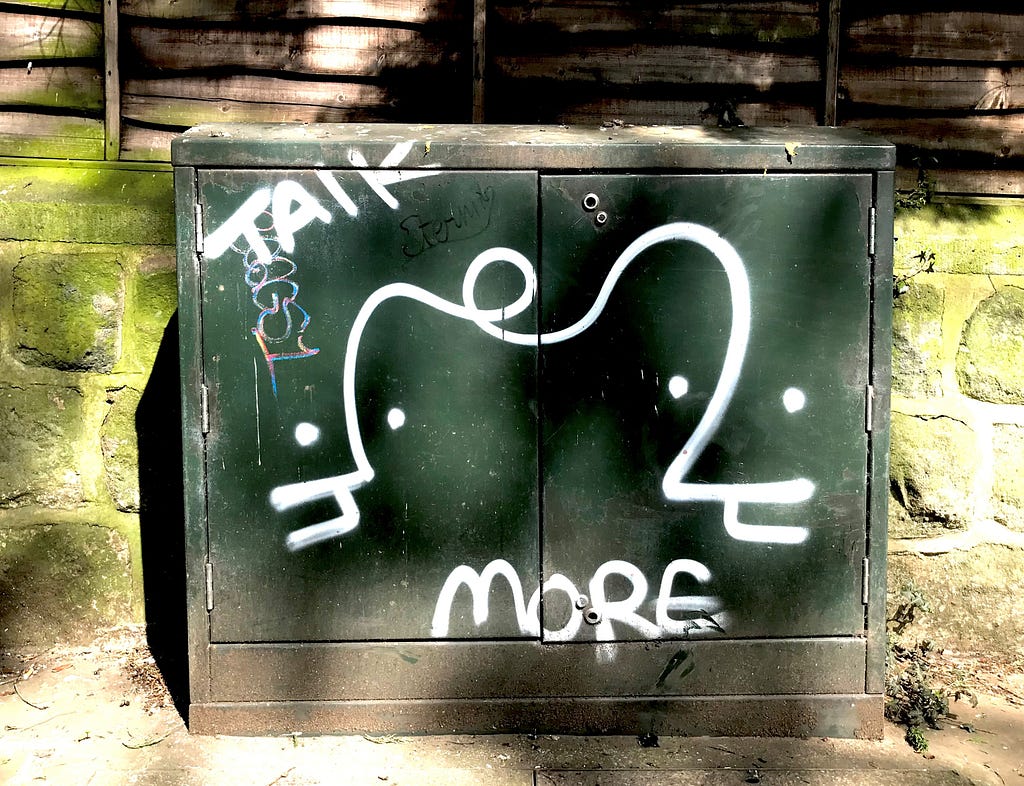 Street art, local to Leeds, which features the words: talk more.