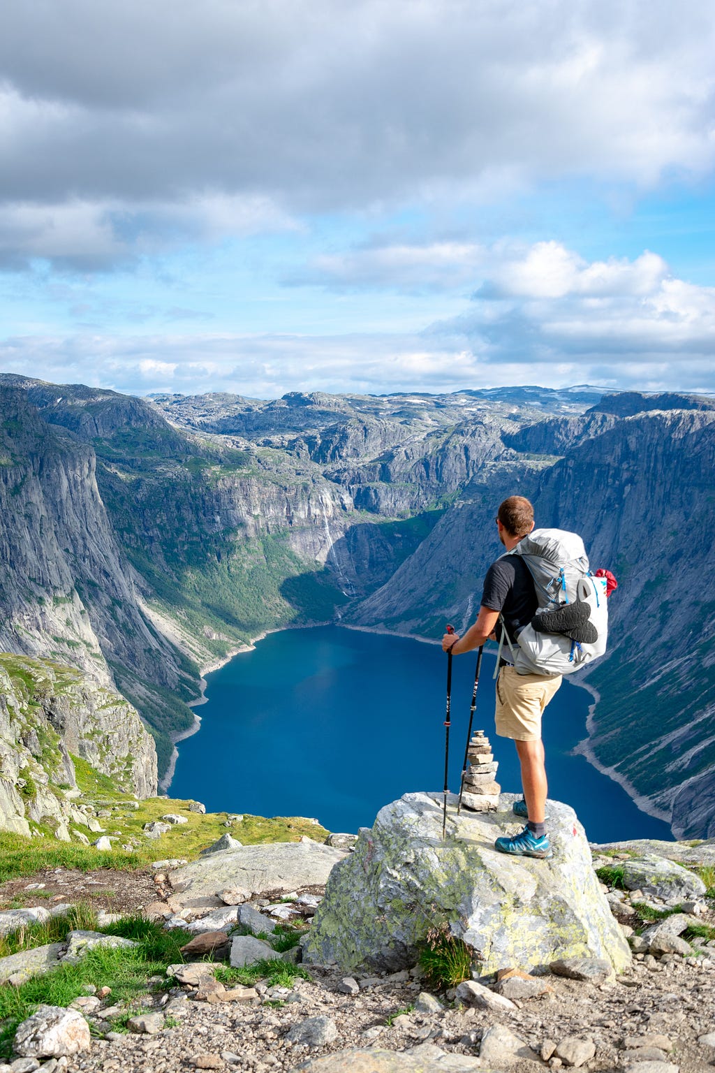 A mountain hiker watching the panorama and the paths behind and in front of them.