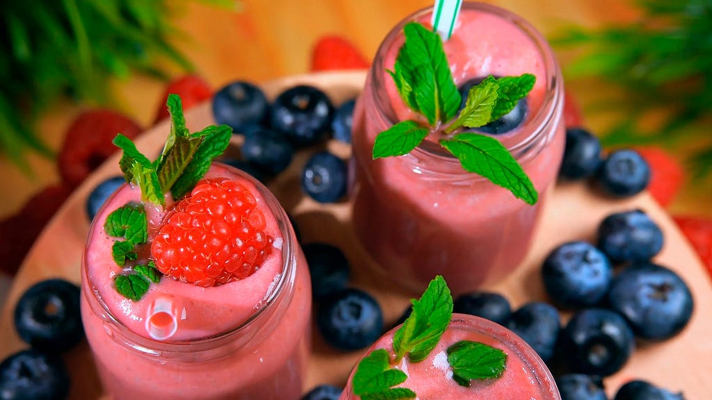 Smoothies containing berries in glasses