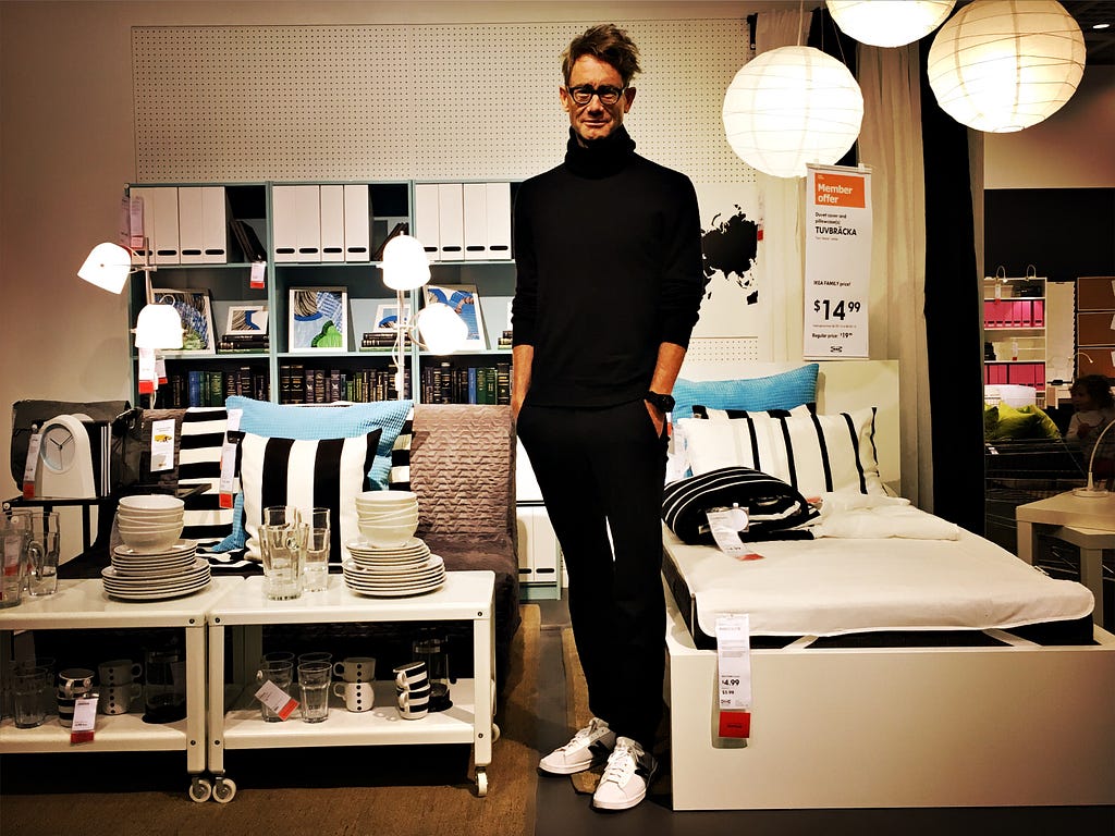 The author, a Swede, in a staged IKEA room — a diorama of corporate liminality