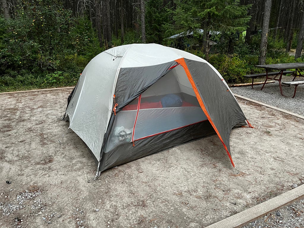 a backpacking tent on a sand tent pad at the West Glacier KOA